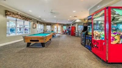 a games room with pool tables and arcade machines at RS2508 Windsor Hills Resort 3 Bedroom Private Pool Townhome in Orlando