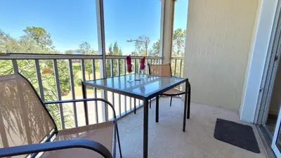 a balcony with a glass table and two chairs at Windsor Palm 3 bed Condo in Kissimmee