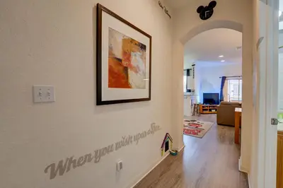 a hallway with a picture hanging on a wall at Disney Family Fun at Regal Oaks in Orlando