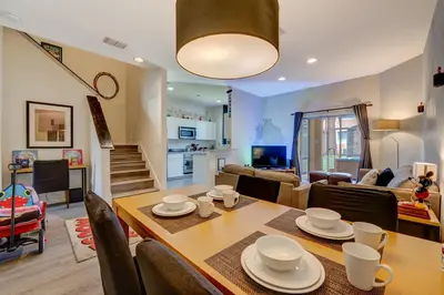 a dining room and living room with a table and chairs at Disney Family Fun at Regal Oaks in Orlando