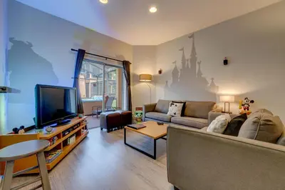 a living room with a couch and a tv at Disney Family Fun at Regal Oaks in Orlando