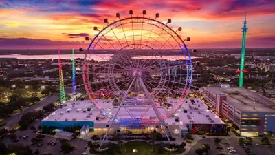 an amusement park with a ferris wheel at sunset at Orlando 2BR Mins to Universal and More in Orlando