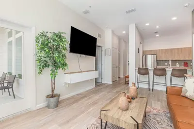 a living room with a couch and a table at Orlando 2BR Mins to Universal and More in Orlando