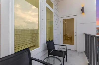 a balcony with two chairs and a table at Orlando 2BR Mins to Universal and More in Orlando