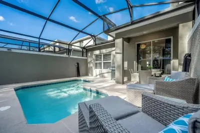a swimming pool in a house with a glass ceiling at Casa 5Q c/ Piscina e Temas Disney — Storey Lake in Kissimmee