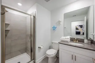 a bathroom with a shower and a toilet and a sink at Casa 5Q c/ Piscina e Temas Disney — Storey Lake in Kissimmee