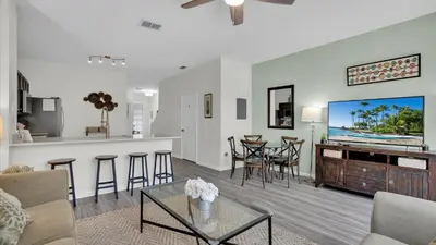 a living room with a tv and a kitchen at SKC7679 Windsor Hills Resort Vacation Townhome in Orlando