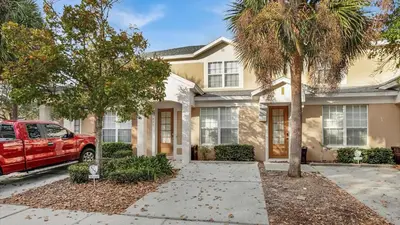 a red truck parked in front of a house at SKC7679 Windsor Hills Resort Vacation Townhome in Orlando