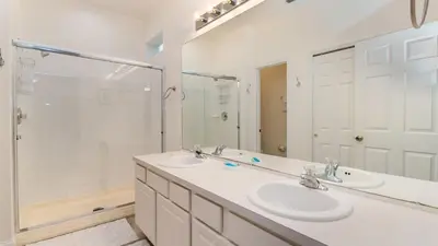 a bathroom with two sinks and a shower at MNL2683 - Windsor Hills Resort Vacation Home - includes resort clubhouse amenity access in Orlando