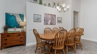 a dining room with a wooden table and chairs at MNL2683 - Windsor Hills Resort Vacation Home - includes resort clubhouse amenity access in Orlando