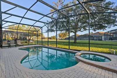a swimming pool with a pergola next to a house at PW2605 Windsor Hills Resort Vacation Home - includes resort clubhouse amenity access in Orlando