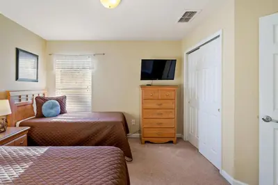 a bedroom with two beds and a flat screen tv at PW2605 Windsor Hills Resort Vacation Home - includes resort clubhouse amenity access in Orlando