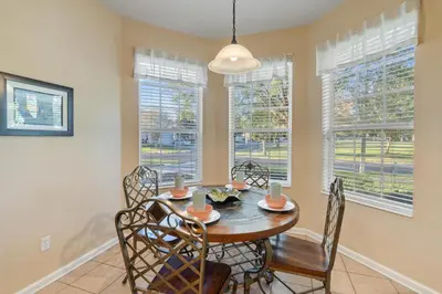 a dining room with a table and chairs and windows at PW2605 Windsor Hills Resort Vacation Home - includes resort clubhouse amenity access in Orlando
