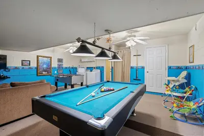 a pool table in a living room with blue walls at PW2605 Windsor Hills Resort Vacation Home in Orlando