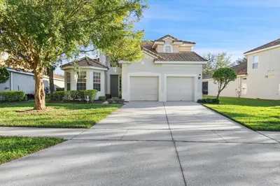 a house with a driveway and a garage at PW2605 Windsor Hills Resort Vacation Home in Orlando