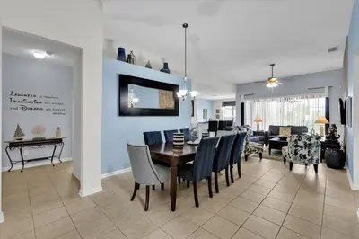 a dining room and living room with a table and chairs at MNL2702 Windsor Hills Resort Vacation Home in Orlando