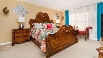 a bedroom with a large wooden bed and a dresser at MNL2696 Windsor Hills Resort Vacation Home - includes resort clubhouse amenity access in Orlando