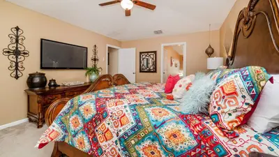 a bedroom with a bed with a colorful quilt at MNL2696 Windsor Hills Resort Vacation Home - includes resort clubhouse amenity access in Orlando