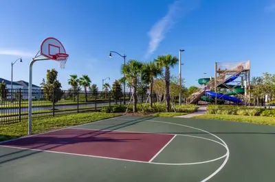 a basketball court in a park with a basketball hoop at 3 Bedrooms 2 Bathrooms Storey Lake 3131-406 in Kissimmee
