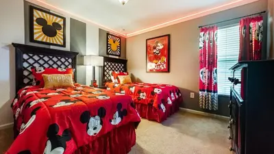 a bedroom with two beds with red comforters at MNL2696 - Windsor Hills Resort Vacation Home - includes resort clubhouse amenity access in Orlando