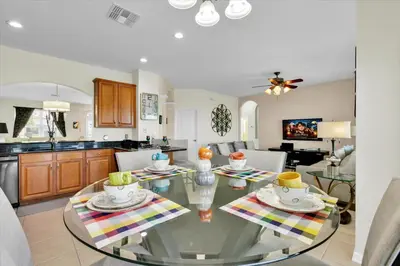a kitchen and living room with a glass table at AF2574 Windsor Hills Resort Vacation Home - includes resort clubhouse amenity access in Orlando