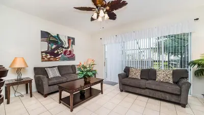 a living room with two couches and a ceiling fan at PP8114 Windsor Palms Resort Vacation Townhome - includes resort clubhouse amenity access in Kissimmee