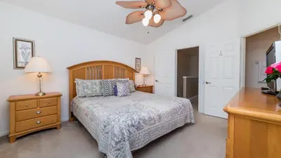 a bedroom with a bed and a ceiling fan at PP8114 Windsor Palms Resort Vacation Townhome - includes resort clubhouse amenity access in Kissimmee