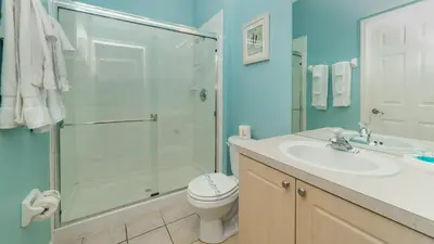 a bathroom with a shower and a toilet and a sink at PP8114 Windsor Palms Resort Vacation Townhome - includes resort clubhouse amenity access in Kissimmee