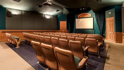 an auditorium with a lecture hall with chairs and a screen at PP8114 Windsor Palms Resort Vacation Townhome in Kissimmee