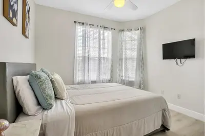a bedroom with a bed and a flat screen tv at Windsor Palms Resort in Kissimmee