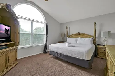 a bedroom with a bed and a large window at Windsor Palms Resort in Kissimmee
