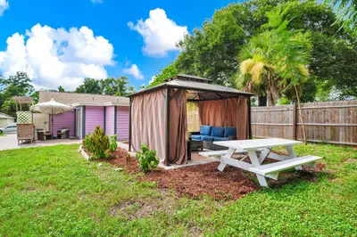 a backyard with a picnic table and a gazebo at Cozy 2bd 2bth House Walk to Local Gems in Orlando