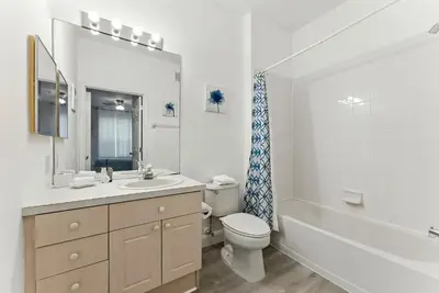a bathroom with a sink and a toilet and a tub at 3BR Resort Condo Pool Balcony Near Disney in Kissimmee