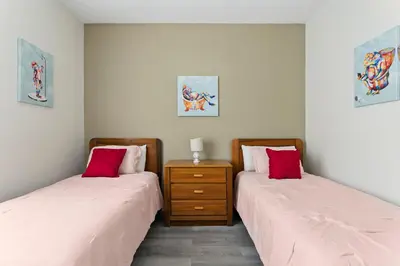 two beds sitting next to each other in a room at 3BR Resort Condo Pool Balcony Near Disney in Kissimmee