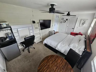 a bedroom with a bed and a desk and a table at Sanford Suite King Bed Work-Ready Near Beach MCO in Sanford