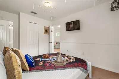 a bedroom with a dog sitting on a bed at 4 Bedrooms 5 Bathrooms Bella Vida 871Mb in Kissimmee