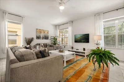 a living room with a couch and a table at 4 Bedrooms 5 Bathrooms Bella Vida 871Mb in Kissimmee