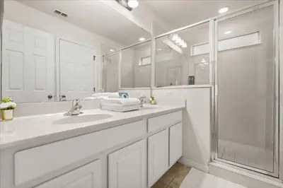 a white bathroom with a sink and a shower at 4 Bedrooms 5 Bathrooms Bella Vida 871Mb in Kissimmee