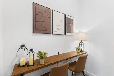 a dining room table with two chairs and two lamps at 8740 Enchanted Stay near Disney in Kissimmee