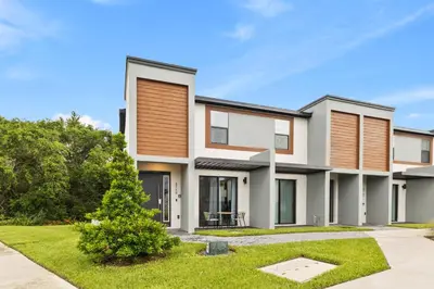 a modern house with a yard at 8740 Enchanted Stay near Disney in Kissimmee