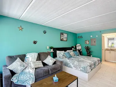 a living room with a couch and a bed at Aqua Azul Oasis in Kissimmee-minutes from Disney in Kissimmee