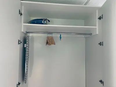 a walk in closet with white walls and white shelves at Aqua Azul Oasis in Kissimmee-minutes from Disney in Kissimmee
