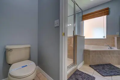 a bathroom with a toilet and a sink and a shower at Terra Verde Lakeview Escape in Kissimmee
