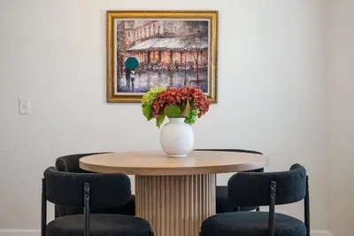 a vase of flowers on a table with two chairs at Winter Park Gem 2BR Near Parks 3MI to Downtown in Orlando