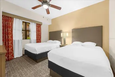 a hotel room with two beds and a ceiling fan at Resort Style Condo 4 miles from Disney in Orlando
