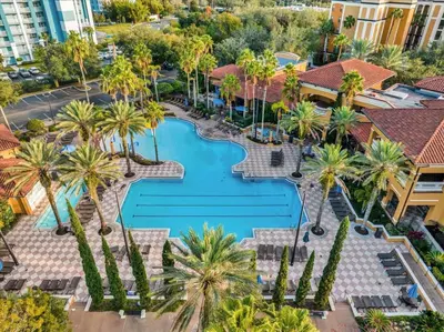 an aerial view of a resort with a pool and palm trees at Resort Style Condo 4 miles from Disney in Orlando