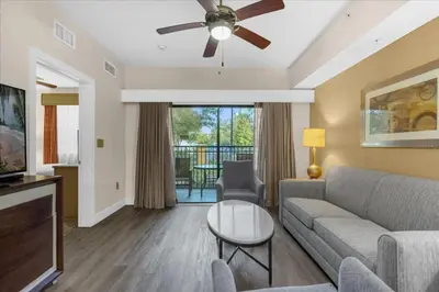 a living room with a couch and a ceiling fan at Resort Style Condo 4 miles from Disney in Orlando