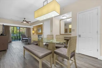 a dining room with a glass table and chairs at Resort Style Condo 4 miles from Disney in Orlando