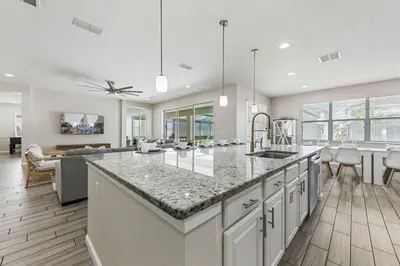 a kitchen and living room with a large counter top at 2605 Yountville Ave in Kissimmee