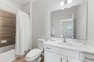 a white bathroom with a toilet and a sink at 2605 Yountville Ave in Kissimmee